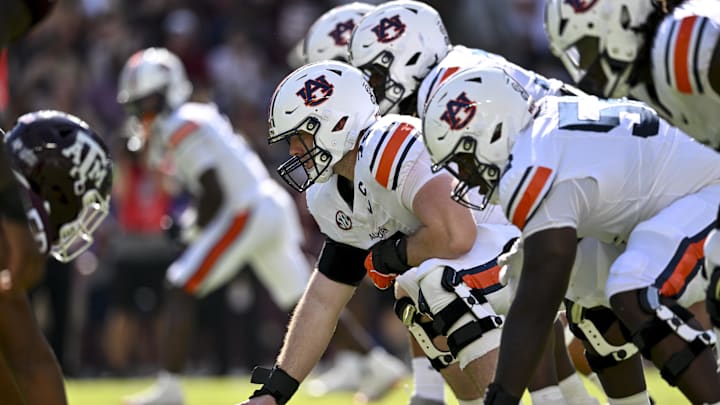Sep 27, 2025; College Station, Texas, USA; Auburn Tigers offensive lineman Connor Lew (75) sets the ball against the Texas A&M Aggies at Kyle Field. Mandatory Credit: Maria Lysaker-Imagn Images 