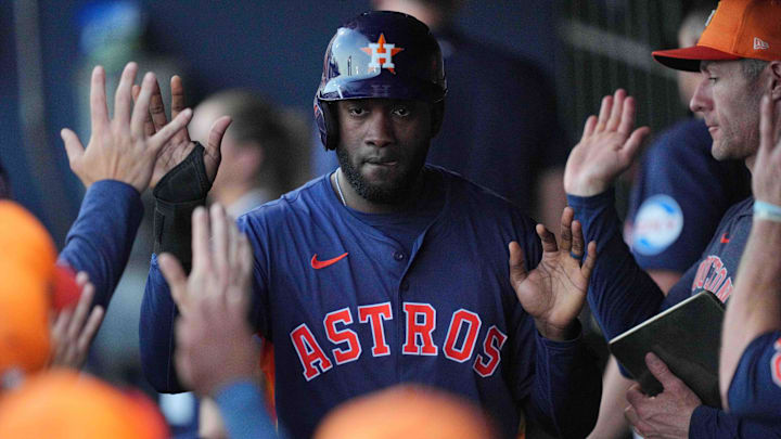 Astros' Yordan Alvarez high fives teammates.