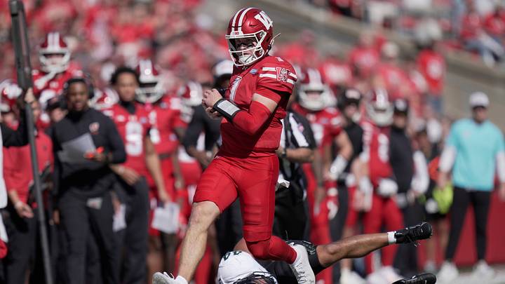 Wisconsin quarterback Colton Joseph (1) runs over Michigan State linebacker Caleb Wheatland (44) for a first down during the first quarter of their game Saturday, October 3, 2026 at Camp Randall Stadium in Madison, Wisconsin.
