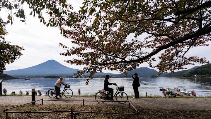 Cyclists riding by Japan's Mount Fuji 