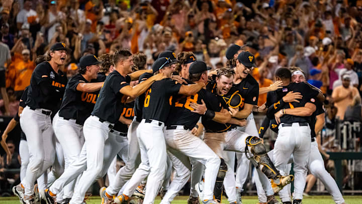 Jun 24, 2024; Omaha, NE, USA; The Tennessee Volunteers dogpile after defeating the Texas A&M Aggies at Charles Schwab Field Omaha. Mandatory Credit: Dylan Widger-Imagn Images