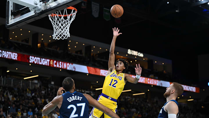 Oct 4, 2024; Palm Desert, California, USA; Los Angeles Lakers guard Max Christie (12) shoot against Minnesota Timberwolves center Rudy Gobert (27) during the first half at Acrisure Arena. Mandatory Credit: Jonathan Hui-Imagn Images