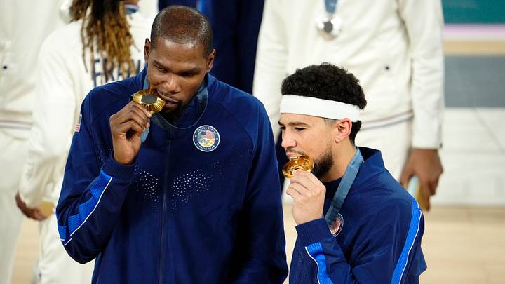 Aug 10, 2024; Paris, France; United States guard Kevin Durant (7) and guard Devin Booker (15) celebrate with their gold medals on the podium after defeating France in the men's basketball gold medal game during the Paris 2024 Olympic Summer Games at Accor Arena. Mandatory Credit: Rob Schumacher-USA TODAY Sports Aug 10, 2024; Paris, France; United States guard Kevin Durant (7) and guard Devin Booker (15) celebrate with their gold medals on the podium after defeating France in the men's basketball gold medal game during the Paris 2024 Olympic Summer Games at Accor Arena. Mandatory Credit: Rob Schumacher-USA TODAY Sports