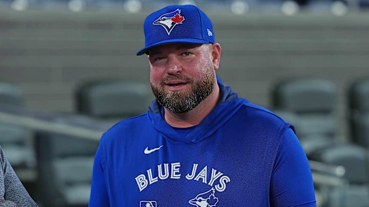 Apr 15, 2025; Toronto, Ontario, CAN; Toronto Blue Jays manager John Schneider (14) talks with the media during batting practice before a game against the Atlanta Braves at Rogers Centre. Apr 15, 2025; Toronto, Ontario, CAN; Toronto Blue Jays manager John Schneider (14) talks with the media during batting practice before a game against the Atlanta Braves at Rogers Centre.