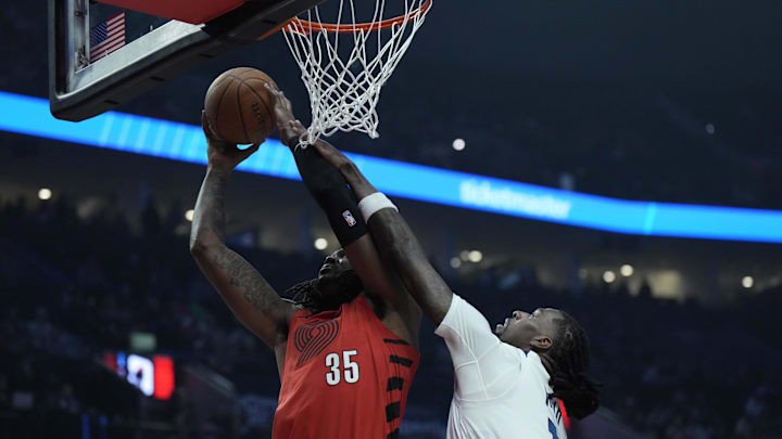 Nov 12, 2024; Portland, Oregon, USA; Portland Trail Blazers center Robert Williams III (35) shoots the ball against Minnesota Timberwolves center Naz Reid (11) during the first half at Moda Center. Mandatory Credit: Soobum Im-Imagn Images
