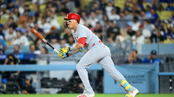 Aug 5, 2025; Los Angeles, California, USA; St. Louis Cardinals center fielder Lars Nootbaar (21) hits a single during the fourth inning against the Los Angeles Dodgers at Dodger Stadium. Mandatory Credit: William Liang-Imagn Images