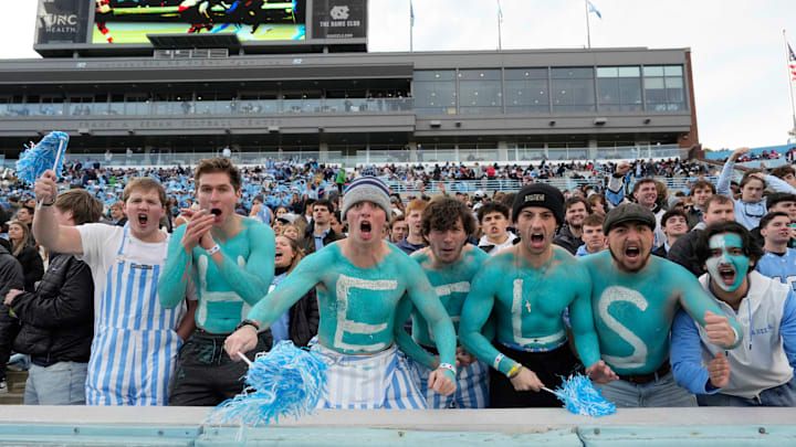 Nov 30, 2024; Chapel Hill, North Carolina, USA; North Carolina Tar Heels fans with Heels painted on their chest cheer in the first quarter at Kenan Memorial Stadium.