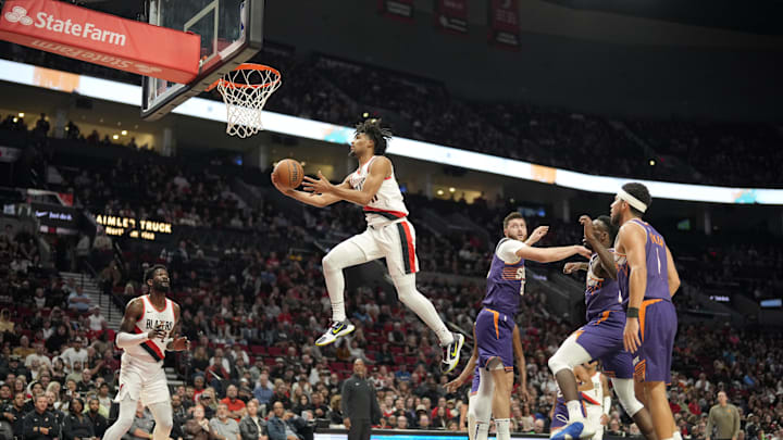 Oct 12, 2023; Portland, Oregon, USA; Portland Trail Blazers shooting guard Shaedon Sharpe (17) drives to the basket past Phoenix Suns center Jusuf Nurkic (20) against during the first half at Moda Center. Mandatory Credit: Soobum Im-Imagn Images