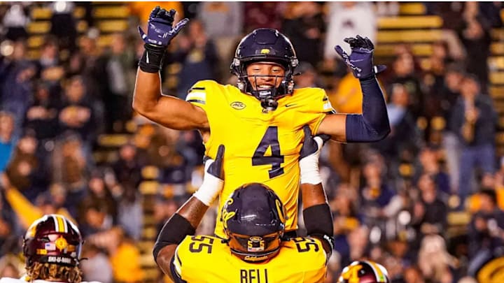 Brent "Paco" Austin is hoisted by Leon Bell after Austin's game-changing play