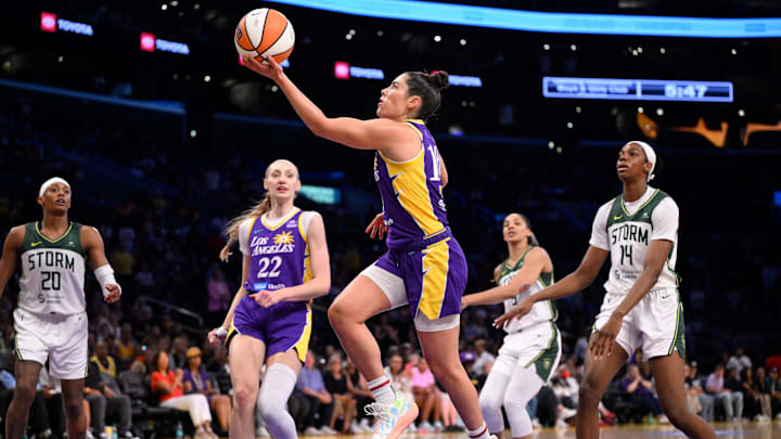 Aug 10, 2025; Los Angeles, California, USA; Los Angeles Sparks guard Kelsey Plum (10) drives to the basket past Seattle Storm center Dominique Malonga (14) during the second quarter at Crypto.com Arena. Mandatory Credit: Robert Hanashiro-Imagn Images