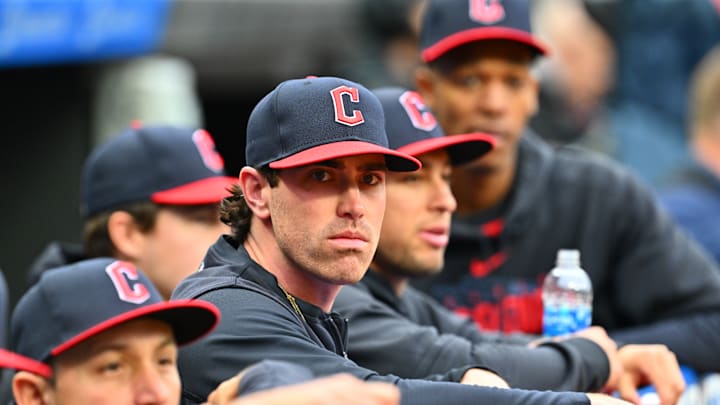 Shane Bieber takes in a Chicago White Sox v Cleveland Guardians game from the dugout.