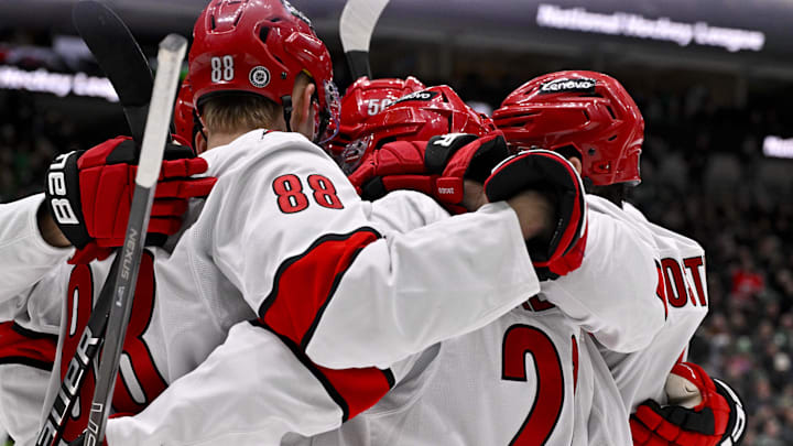 Jan 21, 2025; Dallas, Texas, USA; Carolina Hurricanes center Martin Necas (88) and defenseman Sean Walker (26) and center Jesperi Kotkaniemi (82) and left wing Eric Robinson (50) celebrates a goal scored by Kotkaniemi against the Dallas Stars during the third period at the American Airlines Center. Mandatory Credit: Jerome Miron-Imagn Images