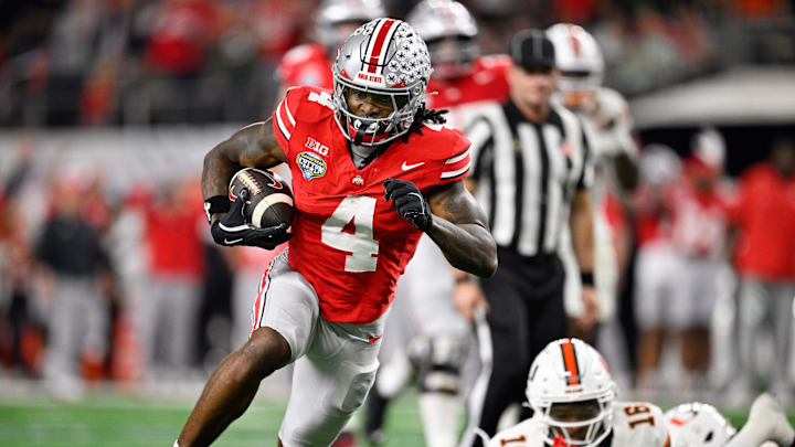 Dec 31, 2025; Arlington, TX, USA; Ohio State Buckeyes wide receiver Jeremiah Smith (4) runs the ball for a touchdown in the third quarter against the Miami Hurricanes during the 2025 Cotton Bowl and quarterfinal game of the College Football Playoff at AT&T Stadium. Mandatory Credit: Jerome Miron-Imagn Images