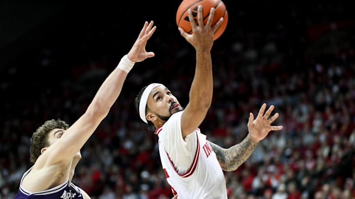 Feb 24, 2026; Bloomington, Indiana, USA; Indiana Hoosiers guard Tayton Conerway (6) scores past Northwestern Wildcats forward Nick Martinelli (2) during the first half at Simon Skjodt Assembly Hall. Mandatory Credit: Robert Goddin-Imagn Images