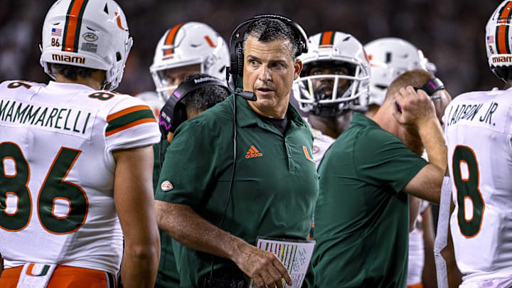 Sep 17, 2022; College Station, Texas, USA; Miami Hurricanes head coach Mario Cristobal talks with