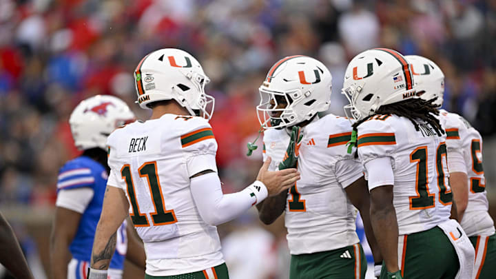 Nov 1, 2025; Dallas, Texas, USA; Miami Hurricanes wide receiver Joshisa Trader (1) and quarterback Carson Beck (11) celebrates a touchdown against the SMU Mustangs during the first quarter at Gerald J. Ford Stadium. Mandatory Credit: Jerome Miron-Imagn Images Nov 1, 2025; Dallas, Texas, USA; Miami Hurricanes wide receiver Joshisa Trader (1) and quarterback Carson Beck (11) celebrates a touchdown against the SMU Mustangs during the first quarter at Gerald J. Ford Stadium. Mandatory Credit: Jerome Miron-Imagn Images