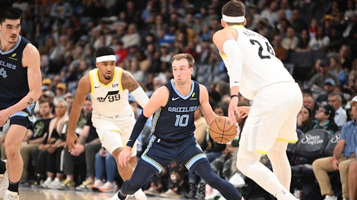Mar 12, 2025; Memphis, Tennessee, USA; Memphis Grizzlies shooting guard Luke Kennard (10) dribbles past defenders during the game at FedExForum. Mandatory Credit: Matthew Smith-Imagn Images