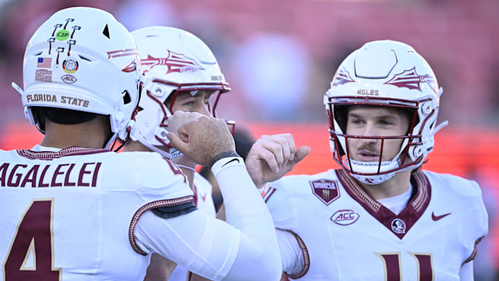 Sep 28, 2024; Dallas, Texas, USA; Florida State Seminoles quarterback DJ Uiagalelei (4) and quarterback Luke Kromenhoek (14) and quarterback Brock Glenn (11) before the game between the Southern Methodist Mustangs and the Florida State Seminoles at Gerald J. Ford Stadium. Mandatory Credit: Jerome Miron-Imagn Images