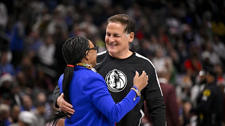 Dec 25, 2024; Dallas, Texas, USA; Mark Cuban hugs retiring Mavericks CEO Cynt Marshall during the game between the Dallas Mavericks and the Minnesota Timberwolves at the American Airlines Center. Mandatory Credit: Jerome Miron-Imagn Images