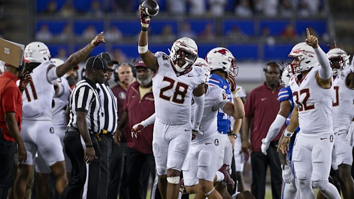 Sep 28, 2024; Dallas, Texas, USA; Florida State Seminoles linebacker Justin Cryer (28) records a Southern Methodist Mustangs fumble during the second half at Gerald J. Ford Stadium. Mandatory Credit: Jerome Miron-Imagn Images