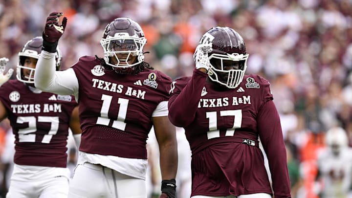 Dec 20, 2025; College Station, TX, USA; Texas A&M Aggies defensive tackle Albert Regis (17) and defensive tackle Tyler Onyedim (11) celebrate during the game between the Aggies and the Hurricanes at Kyle Field. Mandatory Credit: Jerome Miron-Imagn Images