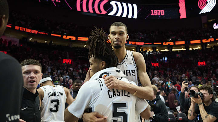 Apr 26, 2026; Portland, Oregon, USA; San Antonio Spurs forward Victor Wembanyama (1) embraces guard Stephon Castle (5) after a game against the Portland Trail Blazers during game four of the first round of the 2026 NBA Playoffs at Moda Center. Mandatory Credit: Troy Wayrynen-Imagn Images