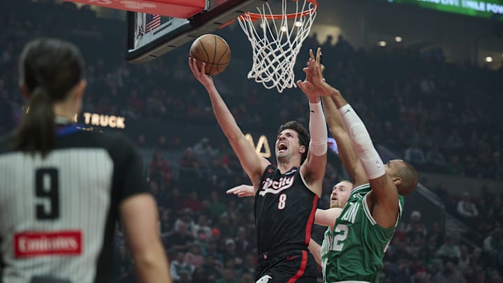 Mar 23, 2025; Portland, Oregon, USA;  Portland Trail Blazers forward Deni Avdija (8) drives to the basket during the first half against Boston Celtics center Al Horford (42) at Moda Center. Mandatory Credit: Troy Wayrynen-Imagn Images