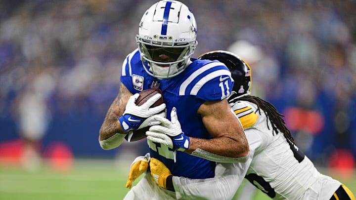 Sep 29, 2024; Indianapolis, Indiana, USA; Indianapolis Colts wide receiver Michael Pittman Jr. (11) is tackled by Pittsburgh Steelers cornerback Donte Jackson (26) during the second quarter at Lucas Oil Stadium. Mandatory Credit: Marc Lebryk-Imagn Images