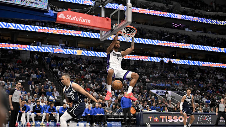 Mar 3, 2025; Dallas, Texas, USA; Sacramento Kings forward Trey Lyles (41) dunks the ball over Dallas Mavericks guard Dante Exum (0) during the second half at the American Airlines Center. Mandatory Credit: Jerome Miron-Imagn Images
