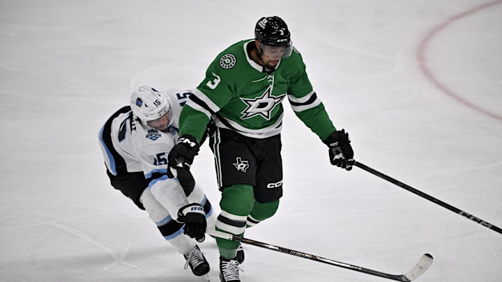 Apr 12, 2025; Dallas, Texas, USA; Dallas Stars defenseman Matt Dumba (3) keeps the puck away from Utah Hockey Club center Alexander Kerfoot (15) during the first period at the American Airlines Center. Mandatory Credit: Jerome Miron-Imagn Images