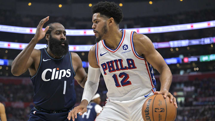 Mar 24, 2024; Los Angeles, California, USA;   Philadelphia 76ers forward Tobias Harris (12) is defended by Los Angeles Clippers guard James Harden (1) in the second half at Crypto.com Arena. Mandatory Credit: Jayne Kamin-Oncea-Imagn Images