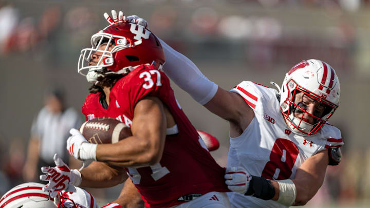 Wisconsin Badgers linebacker Mason Posa (8) grabs the helmet of Indiana Hoosiers tight end Riley Nowakowski (37) Wisconsin Badgers linebacker Mason Posa (8) grabs the helmet of Indiana Hoosiers tight end Riley Nowakowski (37)