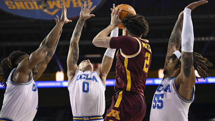 Feb 18, 2025; Los Angeles, California, USA; UCLA Bruins Dylan Andrews (2), Kobe Johnson (0) and Skyy Clark (55) triple team Minnesota Golden Gophers guard Mike Mitchell Jr. (2) during the first half at Pauley Pavilion presented by Wescom. Mandatory Credit: Robert Hanashiro-Imagn Images