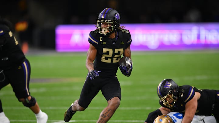 Nov 15, 2024; Seattle, Washington, USA; Washington Huskies running back Cameron Davis (22) carries the ball against the UCLA Bruins during the first half at Alaska Airlines Field at Husky Stadium. Mandatory Credit: Steven Bisig-Imagn Images Nov 15, 2024; Seattle, Washington, USA; Washington Huskies running back Cameron Davis (22) carries the ball against the UCLA Bruins during the first half at Alaska Airlines Field at Husky Stadium. Mandatory Credit: Steven Bisig-Imagn Images