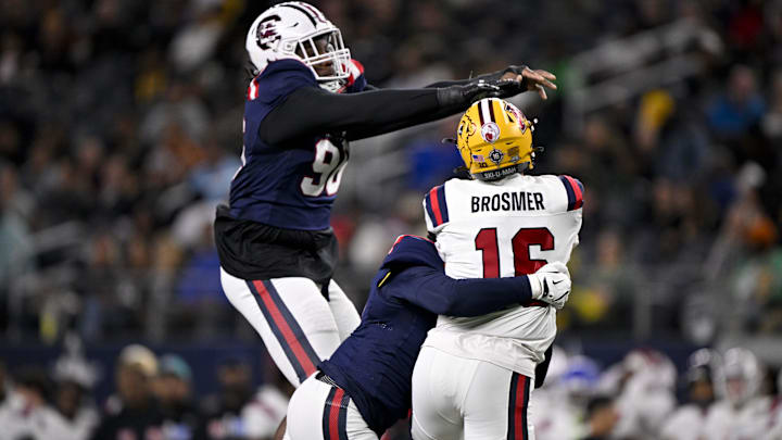 Jan 30, 2025; Arlington, TX, USA; East defensive lineman Tonka Hemingway of South Carolina (96) and East edge rusher Johnny Walker of Missouri (15) sack West quarterback Max Brosmer of Minnesota (16) during the first half at AT&T Stadium. Mandatory Credit: Jerome Miron-Imagn Images
