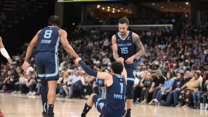 Mar 12, 2025; Memphis, Tennessee, USA; Memphis Grizzlies forward Lamar Stevens (8) (left) and Memphis Grizzlies power forward Brandon Clarke (15) (right) help up teammate Memphis Grizzlies guard Scotty Pippen Jr. (1) (center) in the 3rd quarter of the Utah Jazz vs. Memphis Grizzlies game at FedExForum. Mandatory Credit: Matthew Smith-Imagn Images