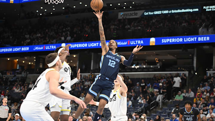 Memphis Grizzlies point guard Ja Morant (12) shoots a floater over Utah Jazz defenders during the game at FedExForum. Mandatory Credit: Matthew Smith-Imagn Images