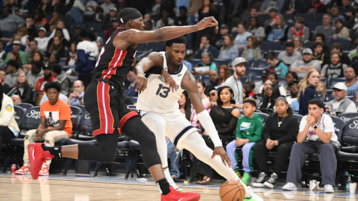 Memphis Grizzlies power forward Jaren Jackson Jr. (13) drives down the sideline against Miami Heat center Bam Adebayo (13) in the third quarter of the game against the Miami Heat at FedExForum. Mandatory Credit: Matthew Smith-Imagn Images
