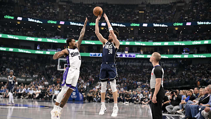 Mar 3, 2025; Dallas, Texas, USA; Dallas Mavericks guard Klay Thompson (31) attempts a three point shot over Sacramento Kings guard Malik Monk (0) during the first quarter at the American Airlines Center. Mandatory Credit: Jerome Miron-Imagn Images