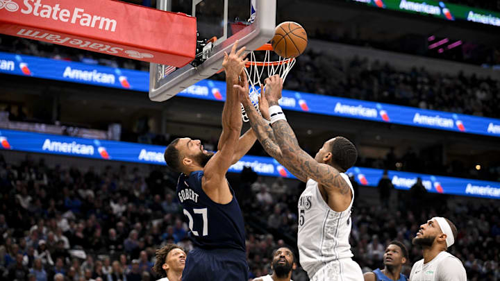 Jan 22, 2025; Dallas, Texas, USA; Minnesota Timberwolves center Rudy Gobert (27) and Dallas Mavericks forward P.J. Washington (25) battle for the rebound during the first half at the American Airlines Center. Mandatory Credit: Jerome Miron-Imagn Images