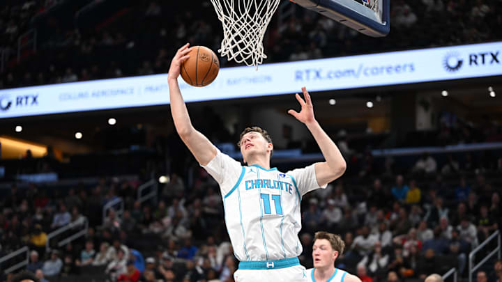 Oct 26, 2025; Washington, District of Columbia, USA; Charlotte Hornets center Ryan Kalkbrenner (11) grabs a rebound against the Washington Wizards during the first quarter at Capital One Arena. Mandatory Credit: Rafael Suanes-Imagn Images