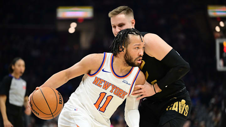 Feb 21, 2025; Cleveland, Ohio, USA;  New York Knicks guard Jalen Brunson (11) drives to the basket against Cleveland Cavaliers guard Sam Merrill (5) during the first half at Rocket Arena. Mandatory Credit: Ken Blaze-Imagn Images