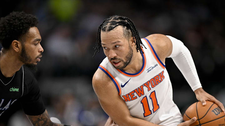 Nov 19, 2025; Dallas, Texas, USA; New York Knicks guard Jalen Brunson (11) looks to move the ball past Dallas Mavericks forward P.J. Washington (25) during the second half at the American Airlines Center. Mandatory Credit: Jerome Miron-Imagn Images