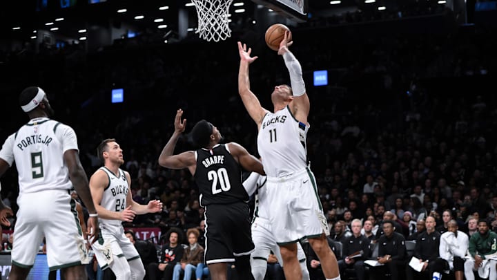 Nov 6, 2023; Brooklyn, New York, USA; Milwaukee Bucks center Brook Lopez (11) rebounds the ball against Brooklyn Nets center Day'Ron Sharpe (20) during the first quarter at Barclays Center. Mandatory Credit: John Jones-Imagn Images
