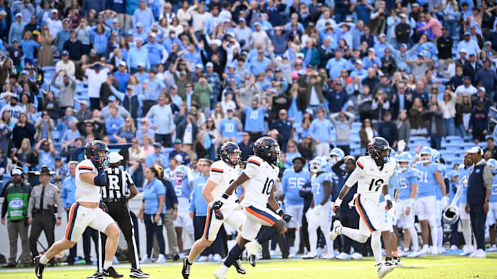 Oct 25, 2025; Chapel Hill, North Carolina, USA; Virginia Cavaliers players celebrate after stopping North Carolina Tar Heels short of the goal line on a two point try to win in overtime at Kenan Stadium. Oct 25, 2025; Chapel Hill, North Carolina, USA; Virginia Cavaliers players celebrate after stopping North Carolina Tar Heels short of the goal line on a two point try to win in overtime at Kenan Stadium.