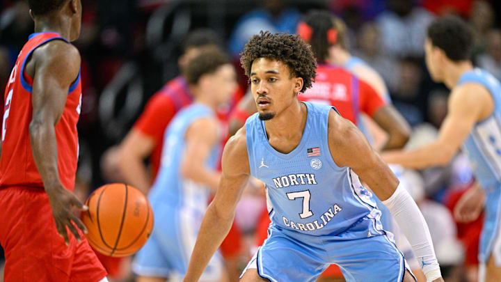 Jan 3, 2026; Dallas, Texas, USA; SMU Mustangs guard Boopie Miller (2) looks to move the ball past North Carolina Tar Heels guard Seth Trimble (7) during the first half at Moody Coliseum. Mandatory Credit: Jerome Miron-Imagn Images