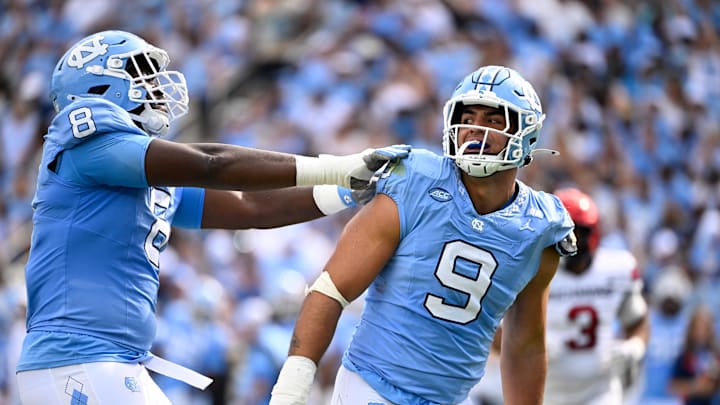 Sep 13, 2025; Chapel Hill, North Carolina, USA; North Carolina Tar Heels defensive lineman Melkart Abou-Jaoude (9 ) celebrates with defensive lineman Smith Vilbert (8) after making a sack in the first quarter at Kenan Stadium. Mandatory Credit: Bob Donnan-Imagn Images