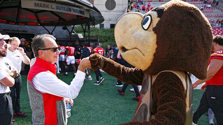 Sep 13, 2025; College Park, Maryland, USA;  Maryland Terrapins mascot Testudo fists bumps athletics director Jim Smith after their game against the Towson Tigers at SECU Stadium. Mandatory Credit: Jamie Sabau-Imagn Images