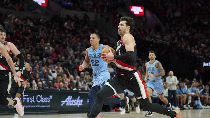Mar 19, 2025; Portland, Oregon, USA; Portland Trail Blazers forward Deni Avdija (8) takes the ball to the basket on a fast break during the second half against Memphis Grizzlies guard Desmond Bane (22) at Moda Center. Mandatory Credit: Troy Wayrynen-Imagn Images