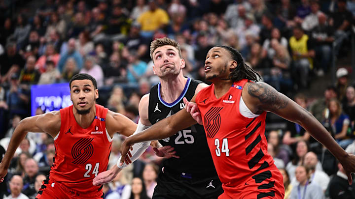 Apr 9, 2025; Salt Lake City, Utah, USA;  Utah Jazz center Micah Potter (25) is boxed out beneath the basket by Portland Trail Blazers forward Kris Murray (24) and forward Jabari Walker (34) in the first half at Delta Center. Mandatory Credit: Jamie Sabau-Imagn Images